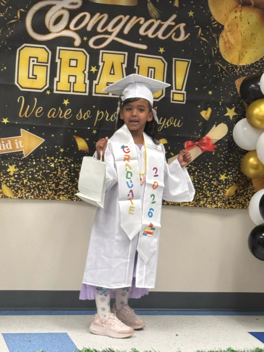 A Rahmah preschool graduate holding her diploma