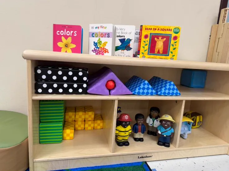 Infant room shelf with board books and toys
