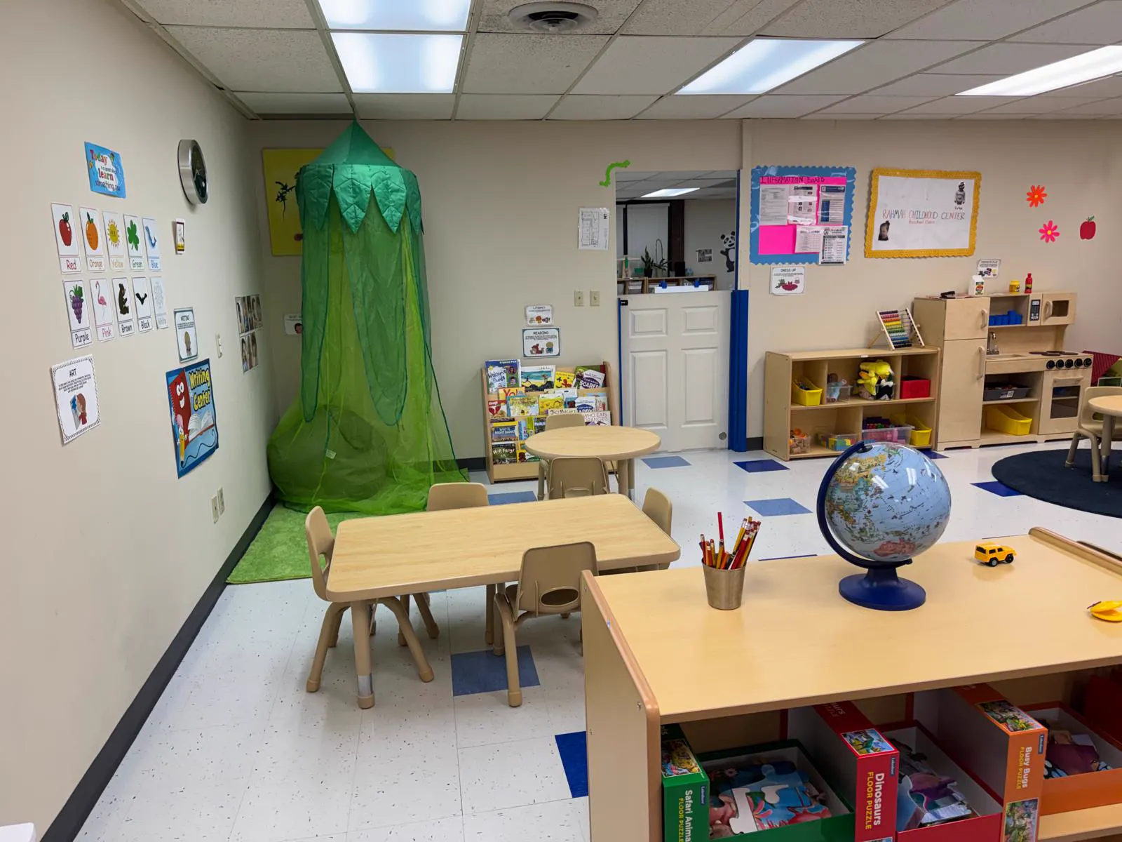Preschool classroom with child-sized tables and a reading tent