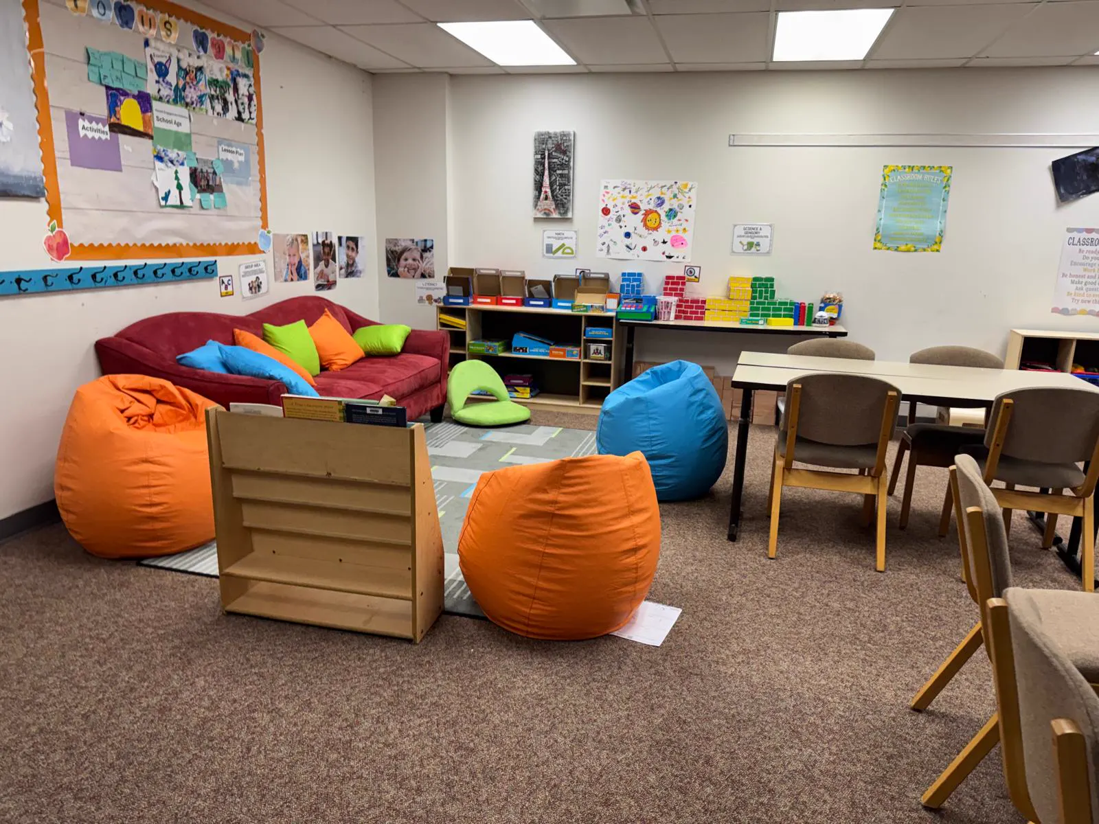 School-age room with bean bags, a sofa and study tables