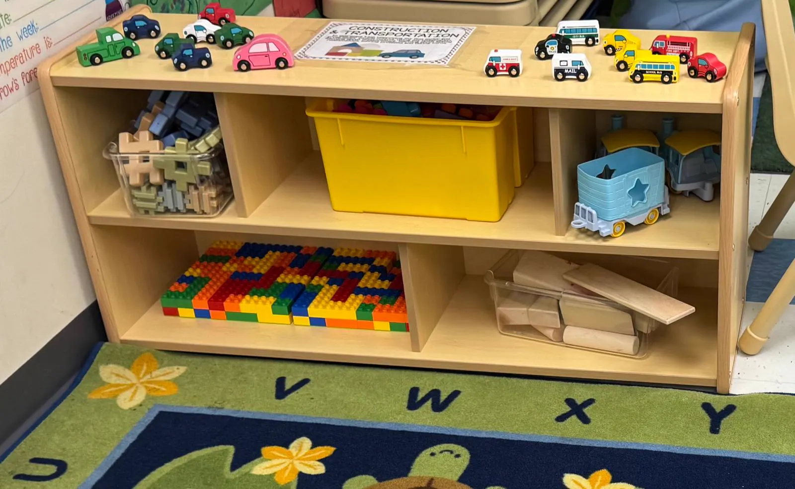 Toddler room shelf with toy cars, building blocks and wooden toys
