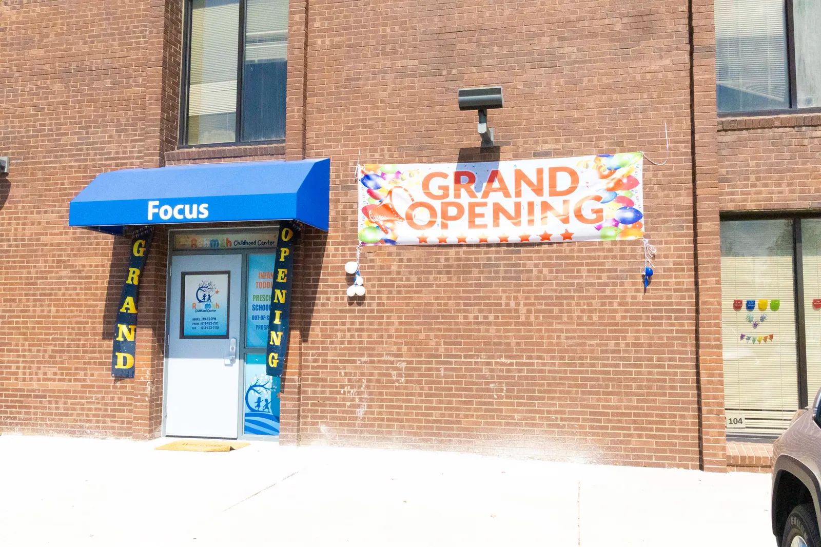 The Rahmah Childhood Center building entrance with a blue awning