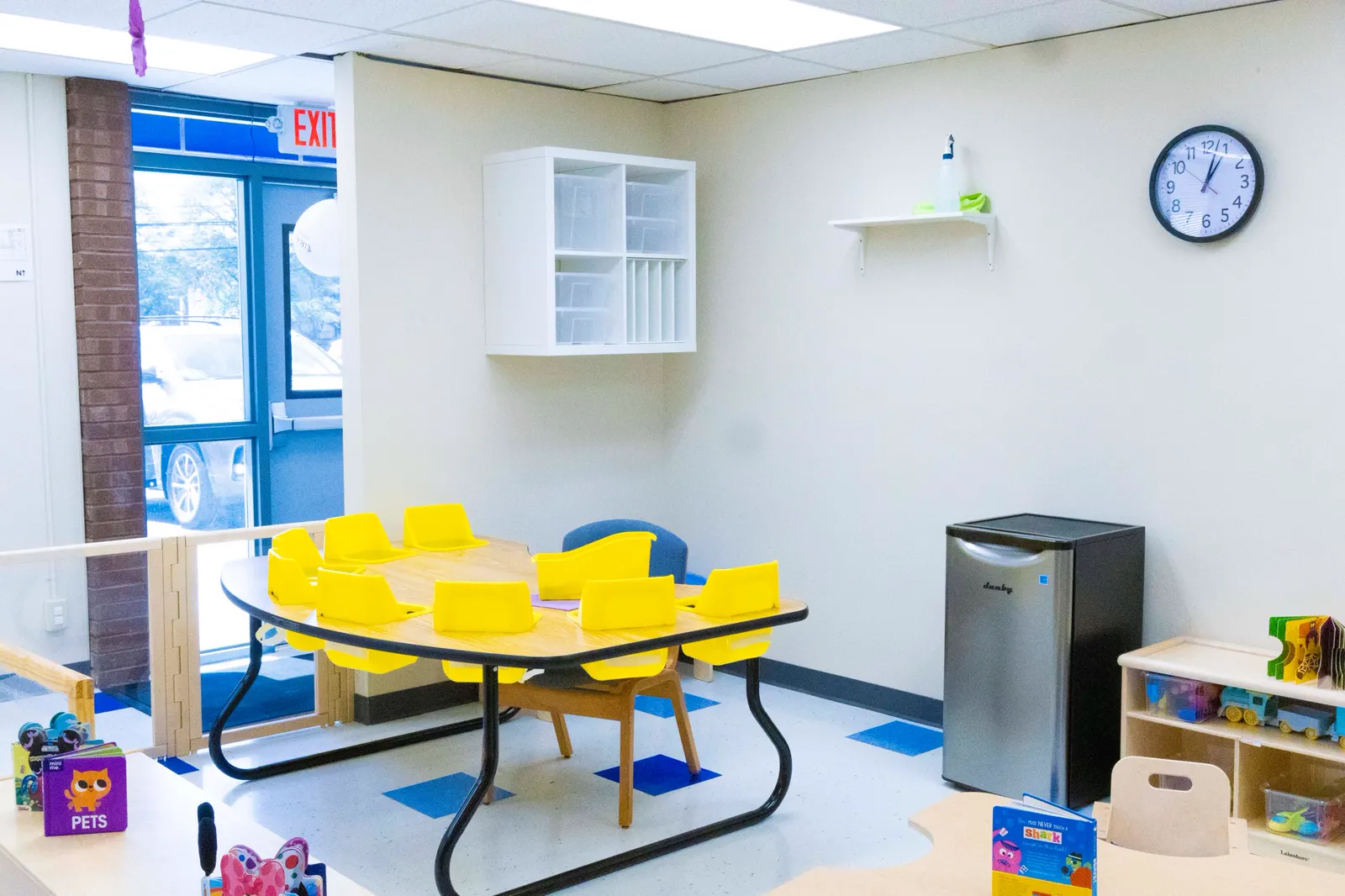 Bright room with child-sized yellow tables and seats